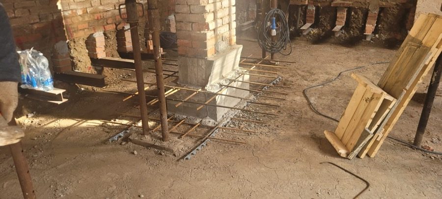 Armatura e getto di rinforzo su un pilastro in un edificio esistente in muratura